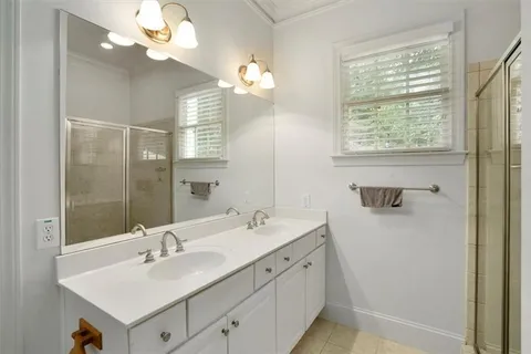 a bathroom with a sink a mirror and a shower