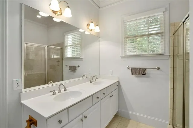 a bathroom with a sink a mirror and a shower