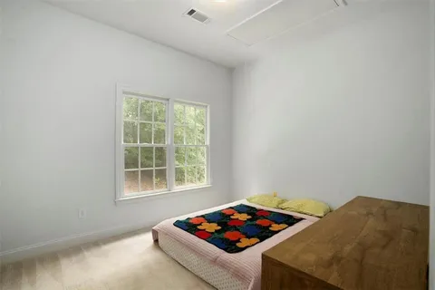 a living room with a bed and a window