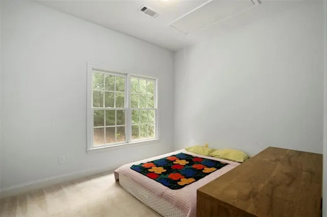 a living room with a bed and a window