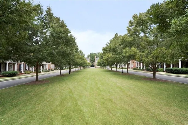 a view of a swimming pool and trees in the background