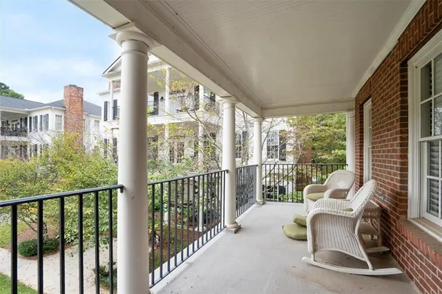 a balcony with furniture and a potted plant