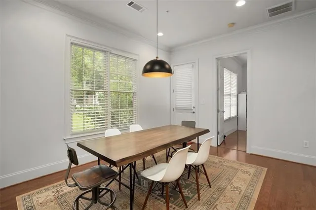 a view of a dining room with furniture window and wooden floor