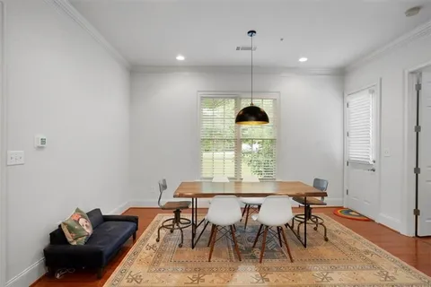 a view of a dining room with furniture and window