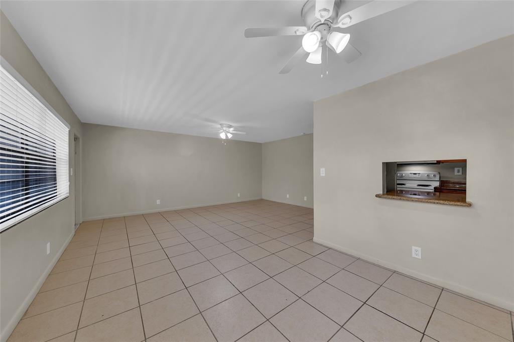 2201 Northeast 36th Street, Unit 205 Lighthouse Point, FL 33064 - Photo 12 of 40 a view of a livingroom with an empty space & a ceiling fan