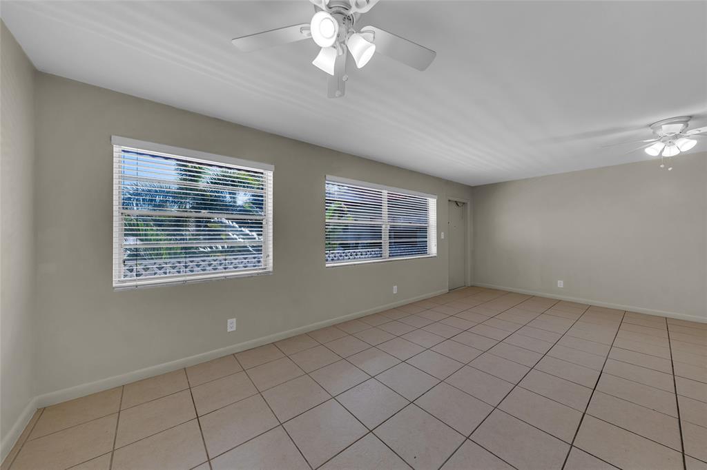 2201 Northeast 36th Street, Unit 205 Lighthouse Point, FL 33064 - Photo 13 of 40 an empty room with windows and ceiling fan