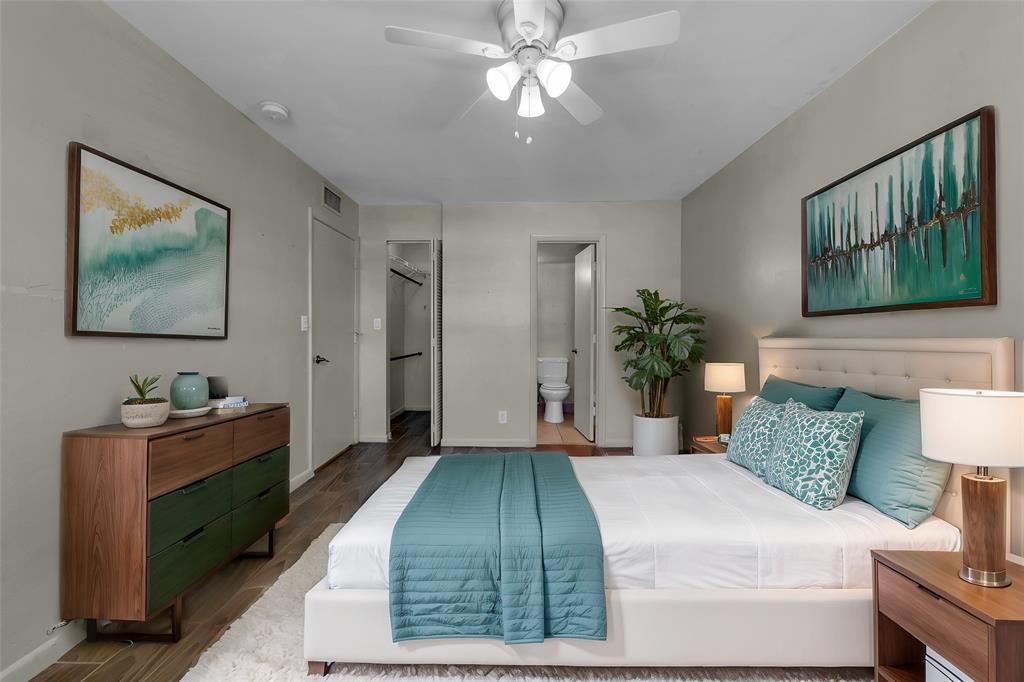 2201 Northeast 36th Street, Unit 205 Lighthouse Point, FL 33064 - Photo 27 of 40 a bedroom with a bed and a chandelier