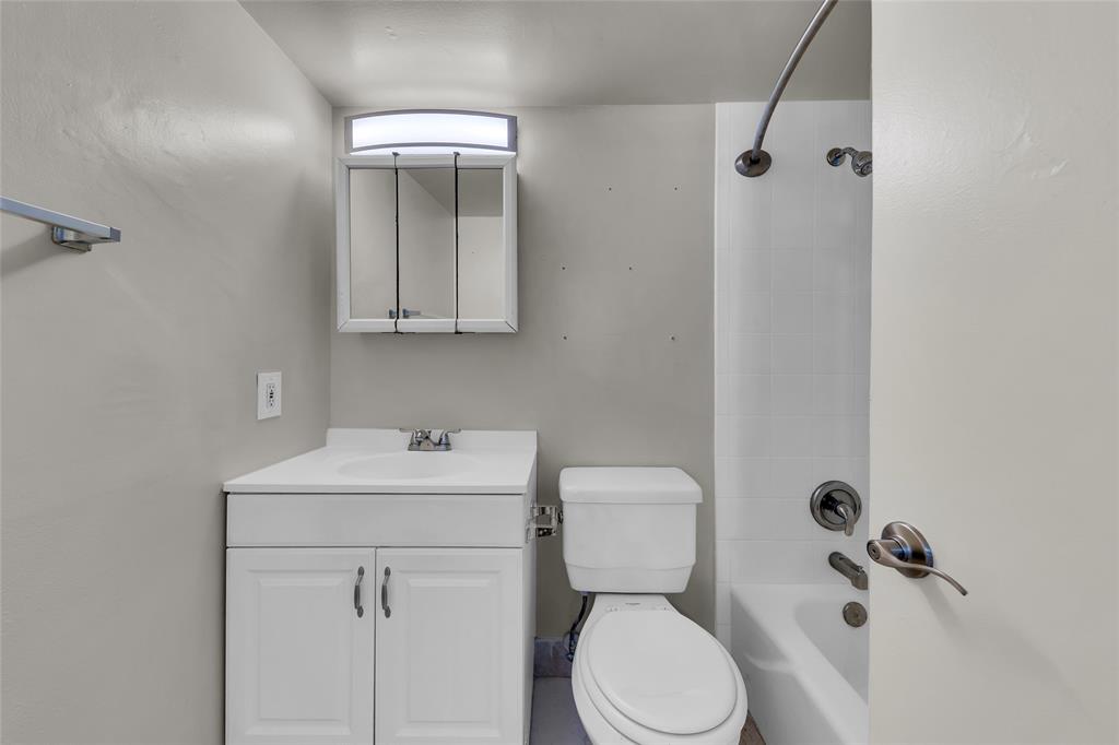 2201 Northeast 36th Street, Unit 205 Lighthouse Point, FL 33064 - Photo 29 of 40 a bathroom with a sink mirror and toilet