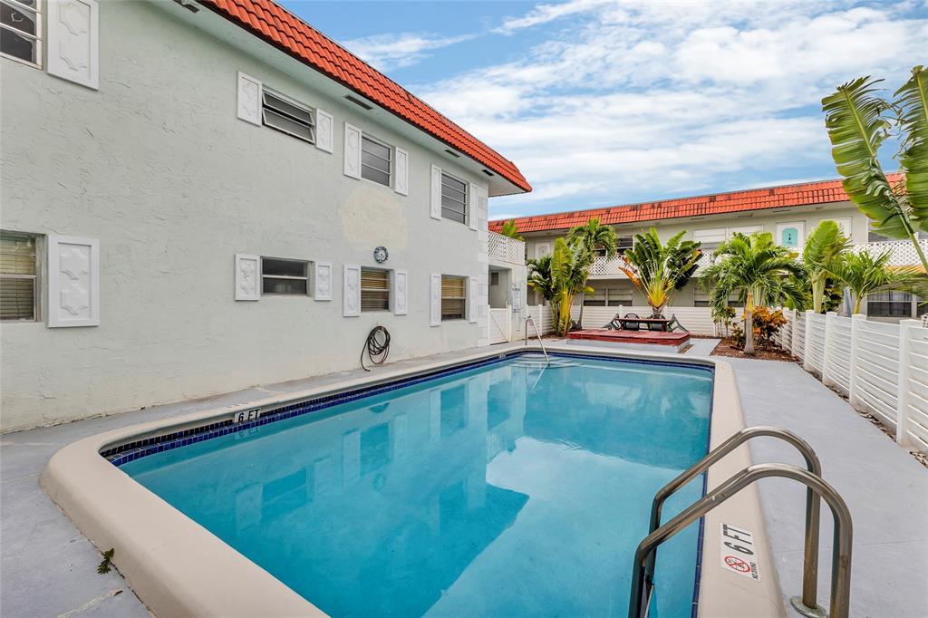 2201 Northeast 36th Street, Unit 205 Lighthouse Point, FL 33064 - Photo 9 of 40 a view of a swimming pool with a patio