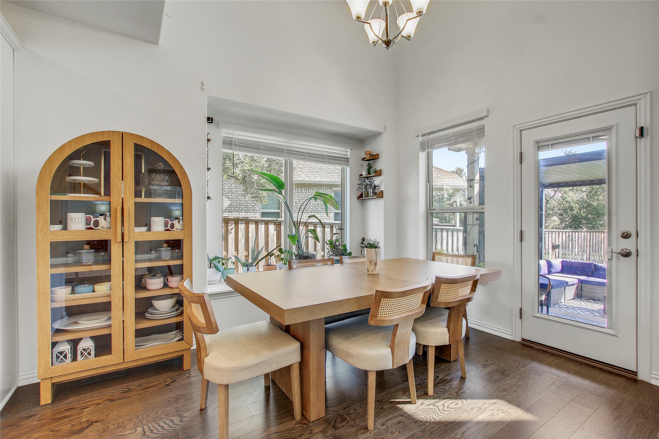 104 Millbend Road Georgetown, TX 78633 - Photo 14 of 40 Hardwood floors and generous windows frame this inviting dining area, ideal for entertaining.