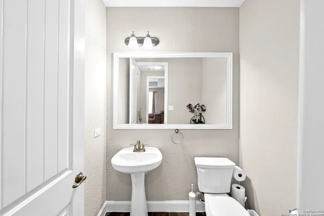 a bathroom with a toilet a sink and a window