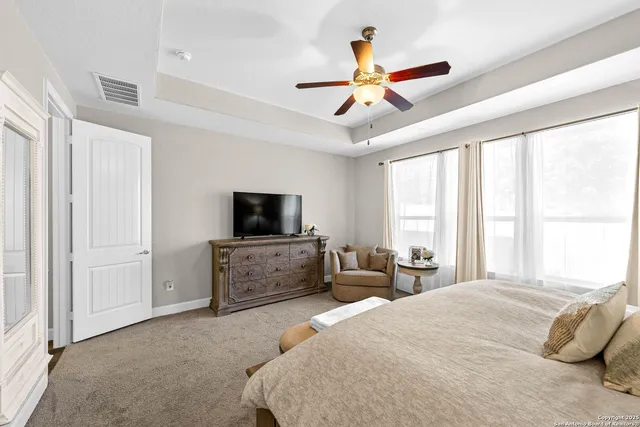 a bedroom with a large bed and a flat screen tv