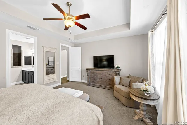 a bedroom with a bed and a television