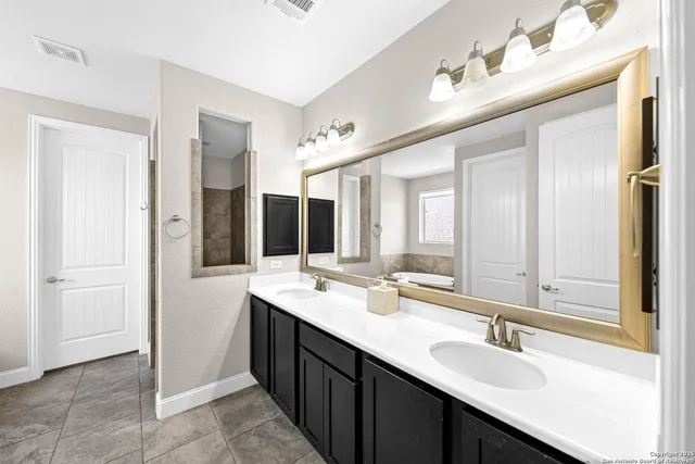 a bathroom with a double vanity sink and mirror