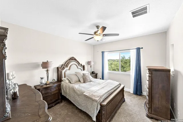 a bedroom with a bed dresser and a window