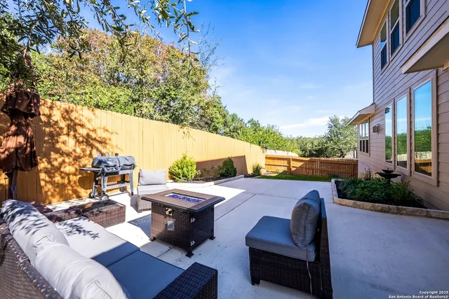 a view of a patio with couches table and chairs and potted plants