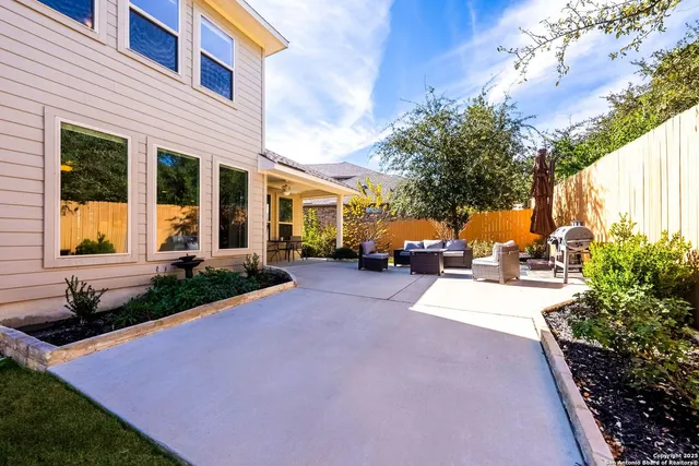 a view of a house with a yard and pathway
