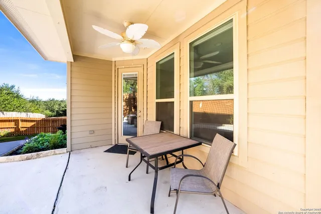 a view of a room with a chairs and table in a patio