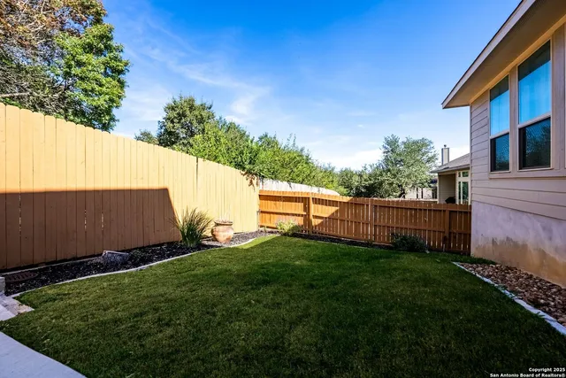 a view of backyard with small cabin