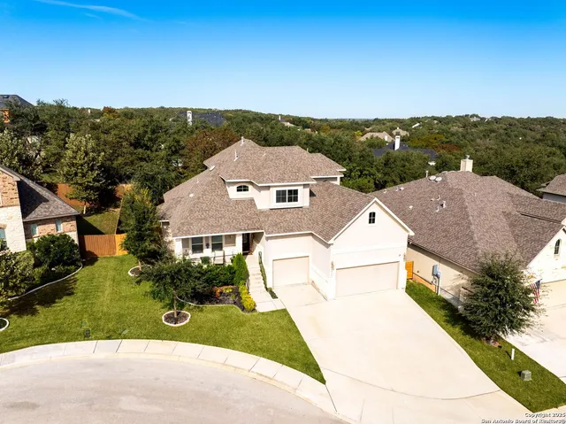 an aerial view of multiple houses with a yard