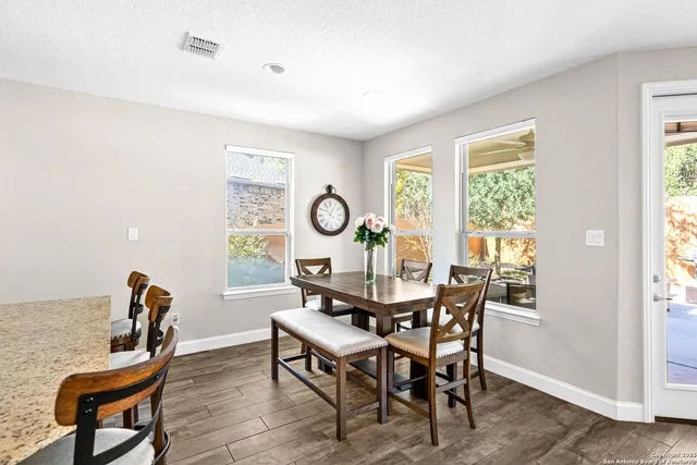 a view of a dining room with furniture and windows