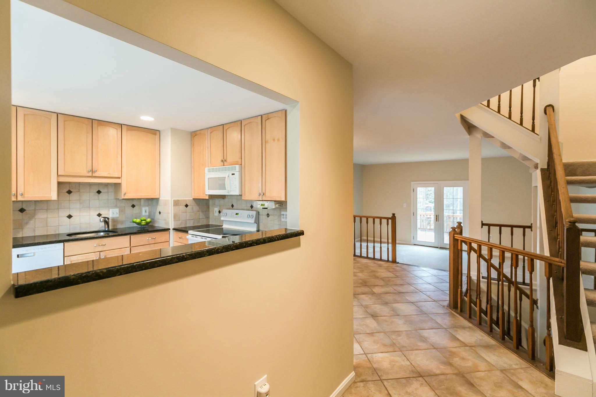 11974 Sentinel Point Court Reston, VA 20191 - Photo 25 of 26 a large kitchen with kitchen island granite countertop a large window and a counter top space