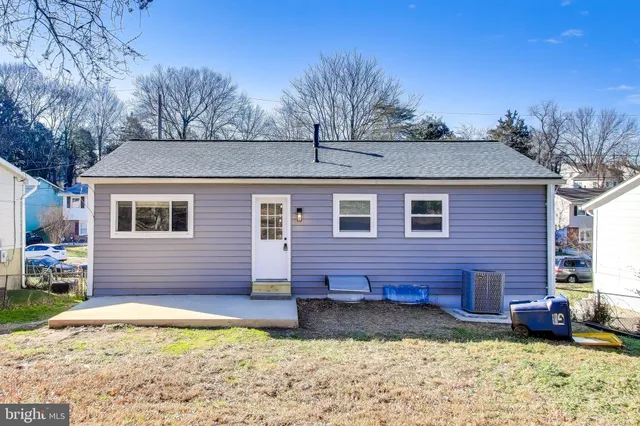 a view of a house with a yard and sitting area