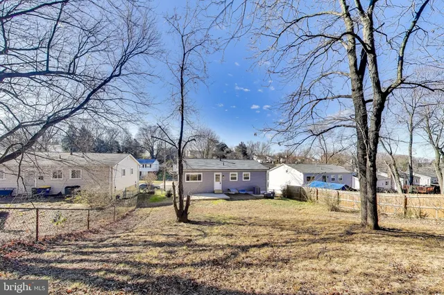 a view of a yard covered with snow in front of house