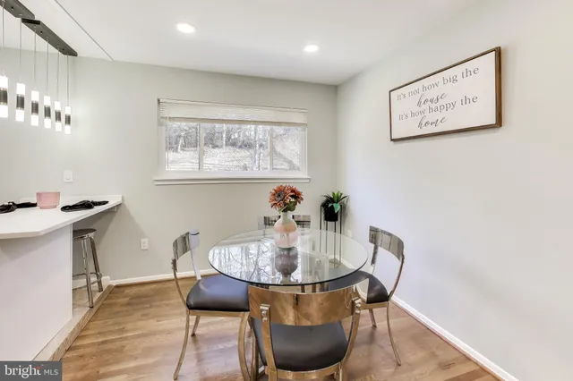 a dining room with furniture and wooden floor