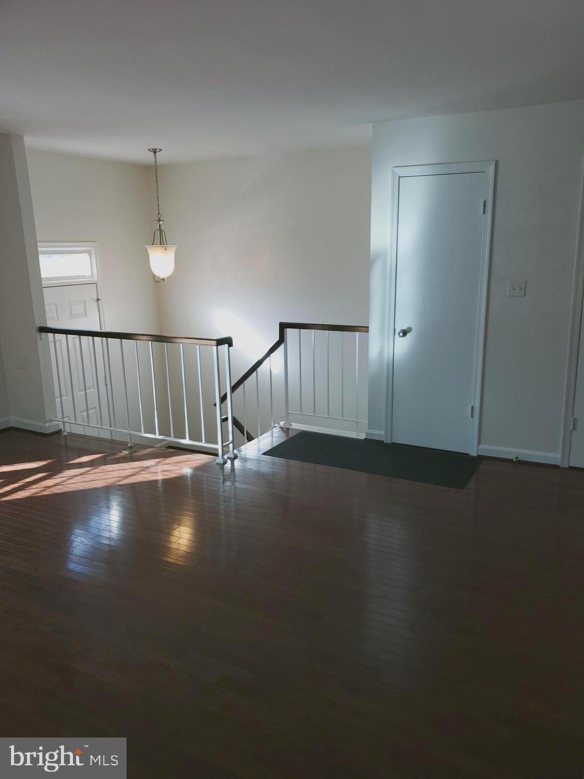 14522 Cambridge Circle Laurel, MD 20707 - Photo 3 of 15 an empty room with wooden floor and windows