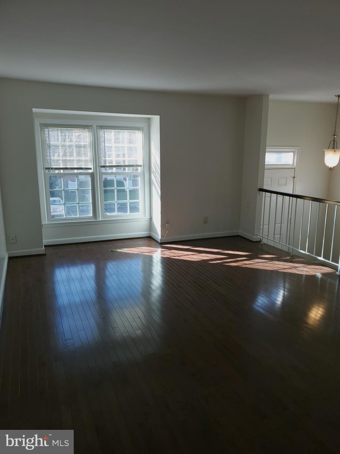 14522 Cambridge Circle Laurel, MD 20707 - Photo 5 of 15 a view of empty room with wooden floor and fan