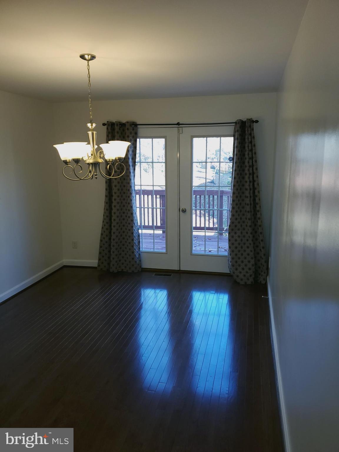 14522 Cambridge Circle Laurel, MD 20707 - Photo 7 of 15 an empty room with wooden floor and windows