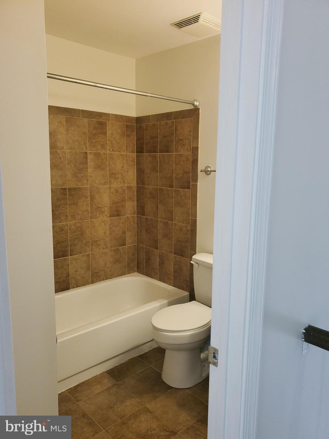 14522 Cambridge Circle Laurel, MD 20707 - Photo 9 of 15 a bathroom with a toilet and a shower