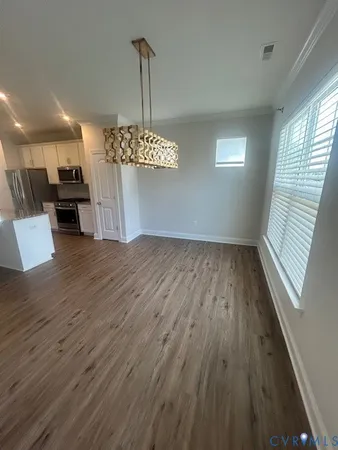 a view of a room with a window and wooden floor