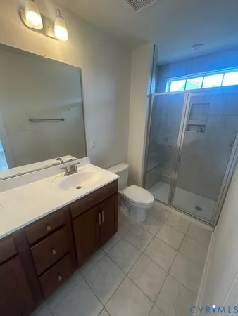 a bathroom with a double vanity sink toilet and shower