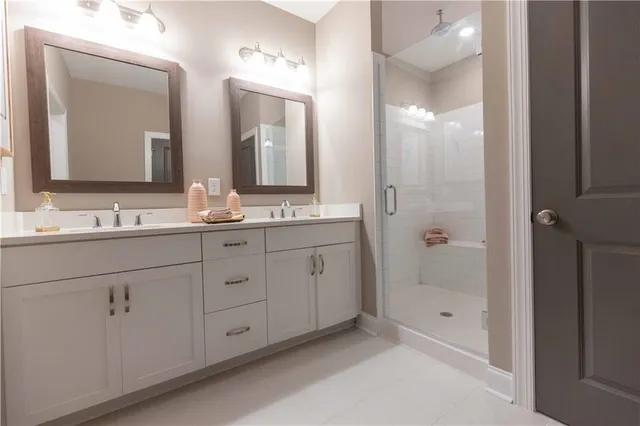a bathroom with double vanity sinks and a mirror