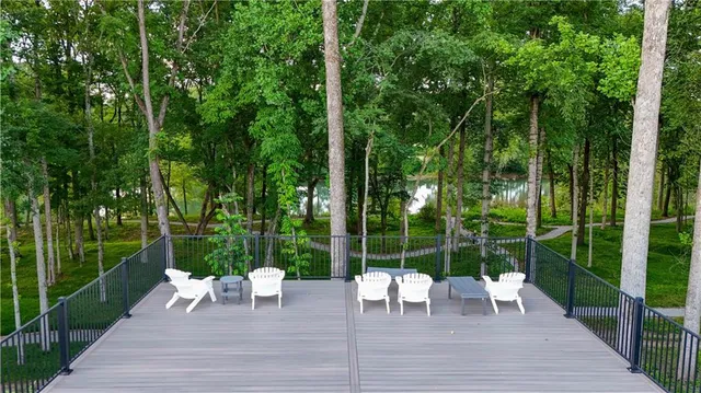 a swimming pool with outdoor seating and garden