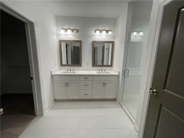 a bathroom with a sink a toilet and mirror