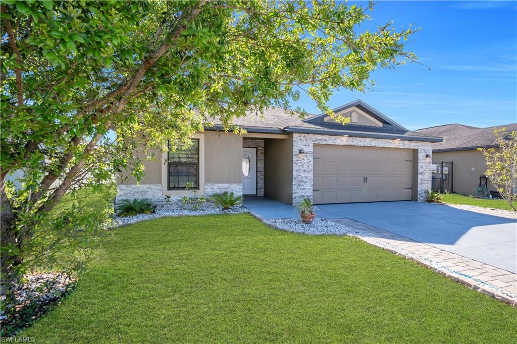 175 Shadowview Court Lehigh Acres, FL 33974 - Photo 6 of 39 a house that has a tree in front of it