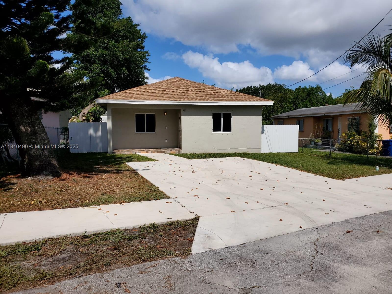 Brownsville Miami, FL 33142 - Photo 2 of 15 a front view of a house with a yard