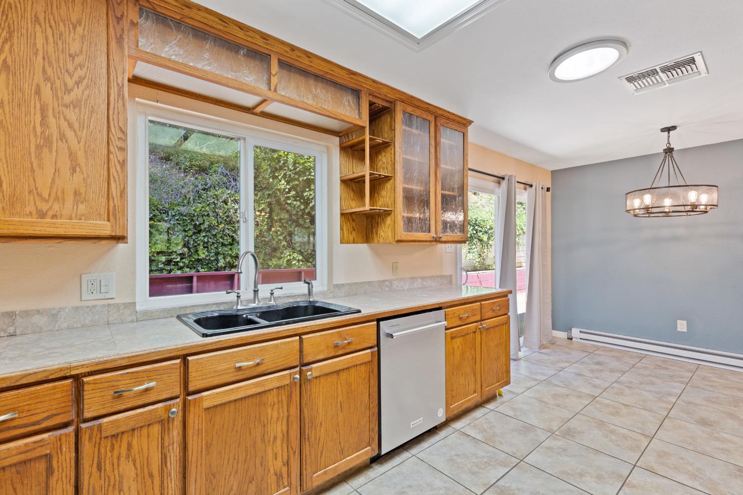 2971 Letitia Avenue Placerville, CA 95667 - Photo 59 of 65 a kitchen with stainless steel appliances granite countertop white cabinets and a window
