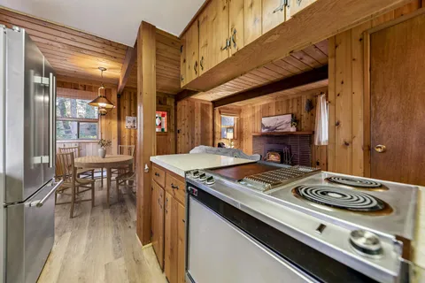 a stove top oven sitting inside of a kitchen