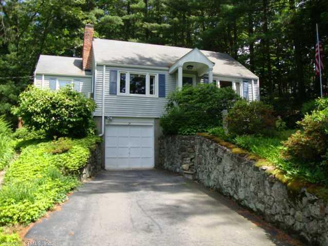 a aerial view of a house with a yard and potted plants