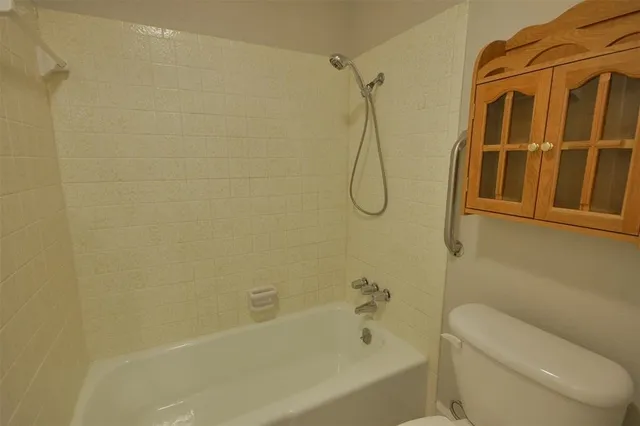 a bathroom with a shower and a toilet