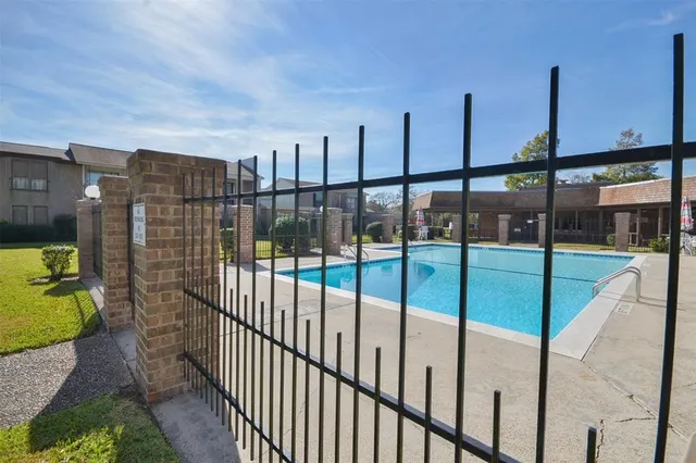 swimming pool view with a seating space and a garden view