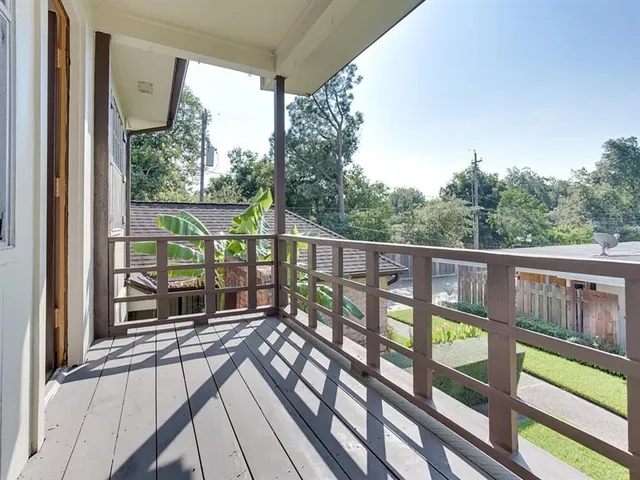 a view of a balcony with wooden floor