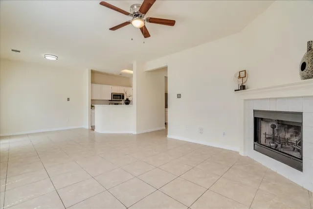 a view of a livingroom with an empty space and a fireplace