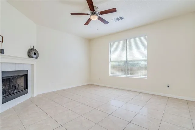a view of empty room with fan and window