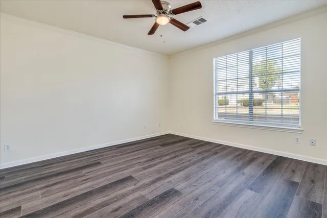 wooden floor in an empty room with a window
