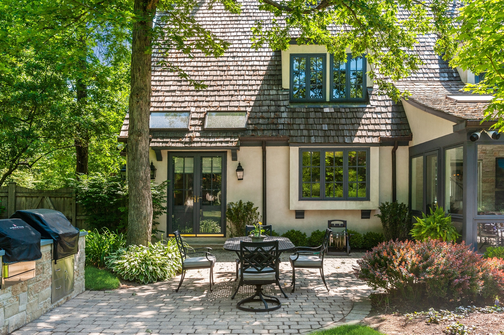 370 North Mayflower Road Lake Forest, IL 60045 - Photo 22 of 29 a view of a house with backyard sitting area and garden